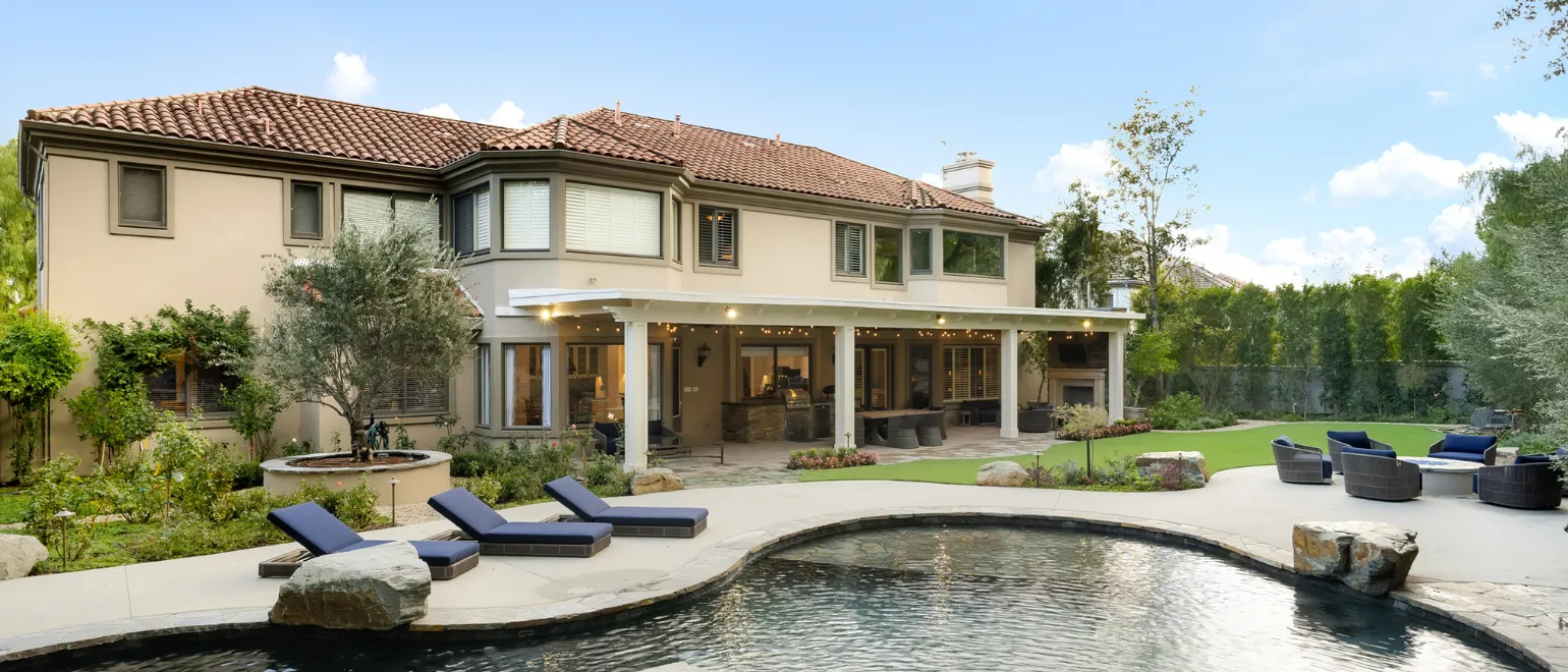 After fire damage restoration project in Los Angeles with restored home exterior, repaired backyard facade, rebuilt outdoor living area, and completed residential recovery work